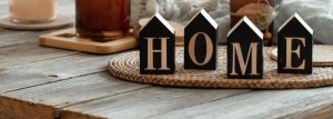 Close Up Decorative Word Home On Blurred Background With Candles.
